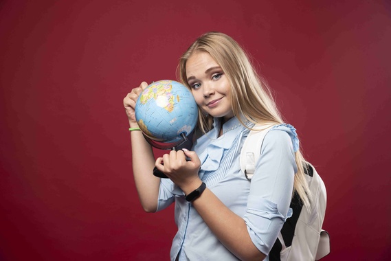 blonde-student-woman-holds-globe.jpg